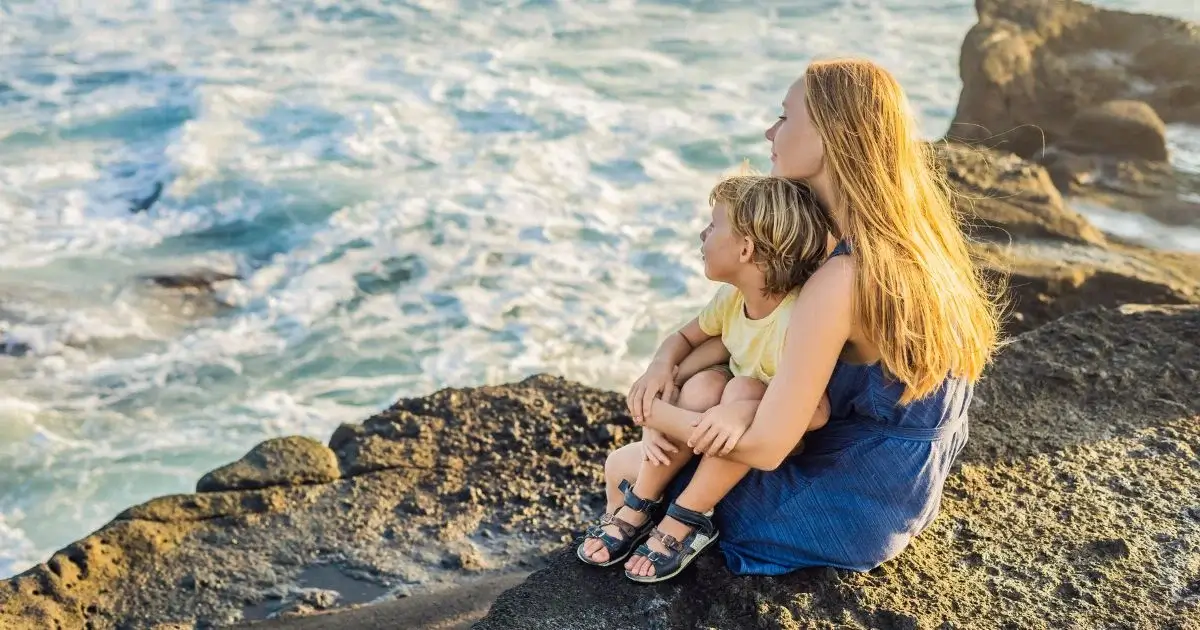 Mother and son enjoying time by the ocean